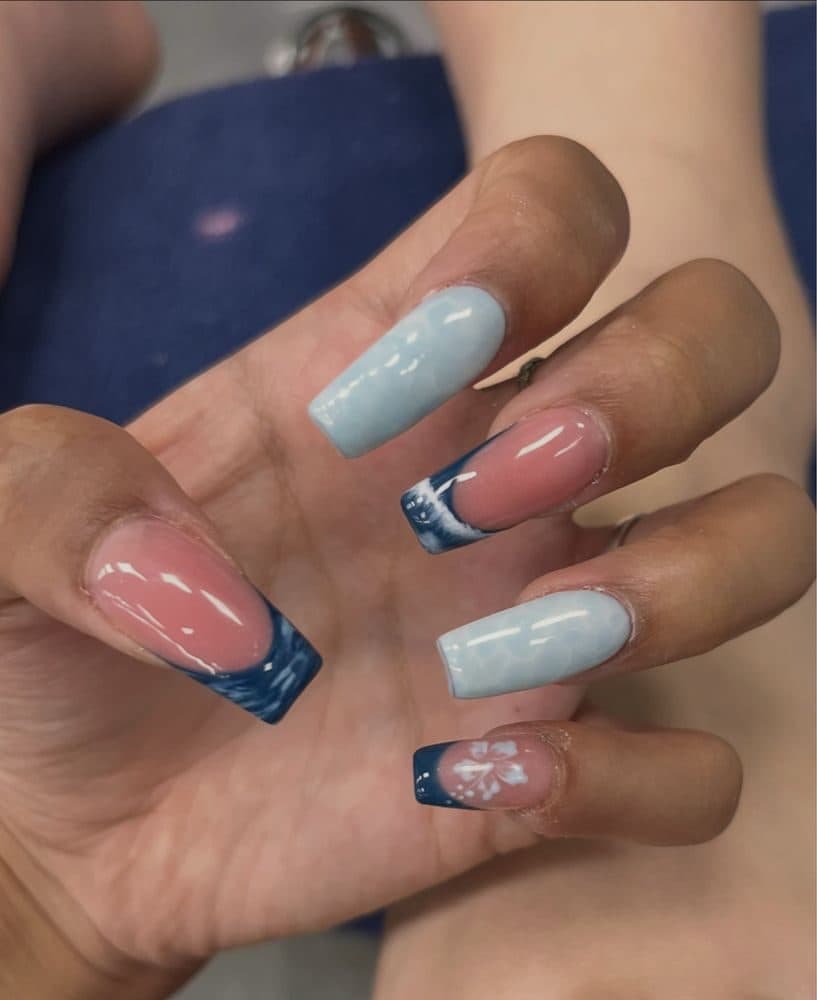 Long coffin nails with navy wave french tips and pale blue marble